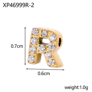 Macro view of gold letter R pendant with micro-paved zircons and precise dimensions