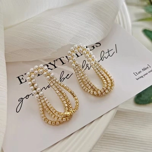 Elegant gold French-style earrings with multi-layer zircon tassels and white pearls