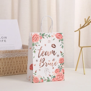 Elegant wedding gift bag with pink roses and gold foiled team bride lettering