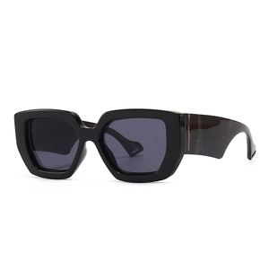 Modern oversized retro sunglasses with black frame and marble pattern wide temples