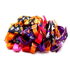 Detailed view of adjustable Halloween pet bow ties with pumpkin and ghost prints