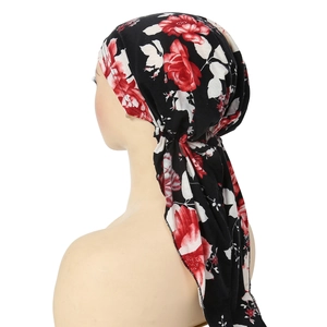Detail of floral headscarf with red rose print and stylish long ties for women