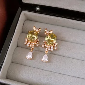 18k gold plated butterfly drop earrings with yellow gemstones and pearl accents