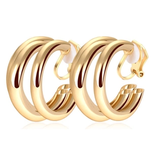 Detailed view of golden double-hoop clip-on earrings with polished metallic texture