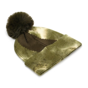 Detail of green and brown tie-dye knit beanie with fluffy faux fur pompom and ribbed texture