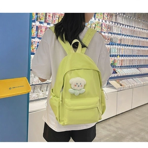Light green nylon backpack with cute bear pendant for students and daily travel use