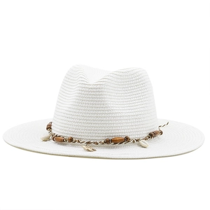 Detail of straw hat featuring sea shells, wooden beads and a gold starfish pendant