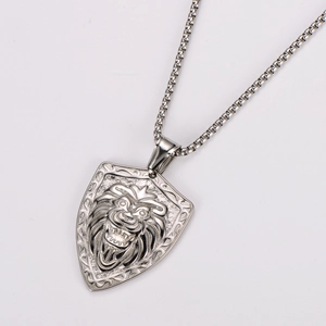 Detailed close-up of a silver stainless steel necklace with a carved lion head shield pendant