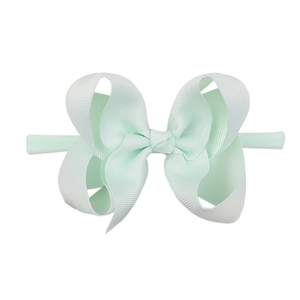 Detail view of light green ribbed ribbon bow on a soft elastic nylon baby headband