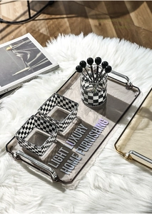 Detail view of checkered acrylic storage containers on a luxury rectangular tray