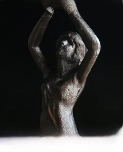 Macro shot of heavy cast iron texture on an artistic angel-style candle holder
