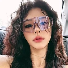 Close-up of lifestyle wear showing gradient purple lenses and oversized frame goggles