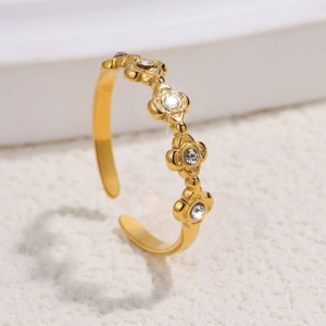 Macro shot of adjustable gold flower ring with sparkling crystals and polished finish