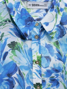 Detail of floral chiffon shirt neckline with gold buttons and brand size labels