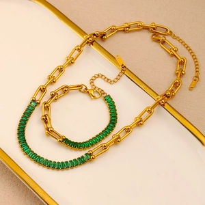 Detail of 316L gold-plated horseshoe link necklace and bracelet set with green zircon