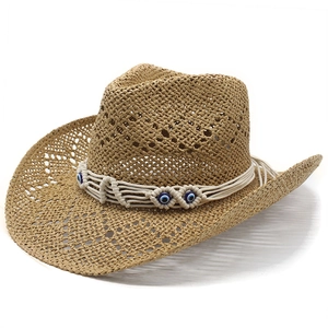 Detail of western straw cowboy hat with evil eye bead and white braided rope band