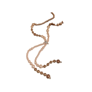 Elegant long champagne pearl sweater necklace with sparkling diamond accents on white backdrop