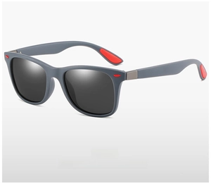 Detail view of grey polarized sunglasses frame with stylish red temple accents