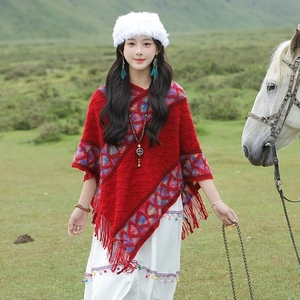 Ethnic red knitted poncho shawl with colorful tassels and geometric patterns for travel
