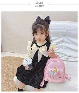 Pink unicorn sequin backpack for kids shown with a child model in a natural setting