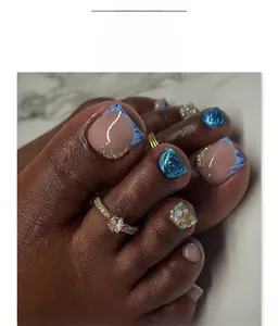 Detail of blue marble and pink French toe nails with pearl and rhinestone accents