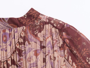 Detailed view of paisley print chiffon fabric with pleated texture and stand collar