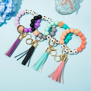 Close-up of silicone beaded keychain bracelets with leather tassels and MAMA letter beads