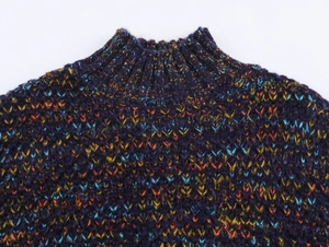 Detail view of space dye mock neck sweater with colorful ribbing and knit texture