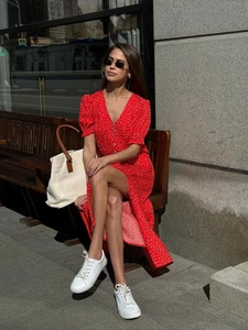 Red V-neck polka dot midi dress with short puff sleeves in a French chic style