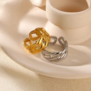 Macro detail of gold and silver chain link rings with a wavy texture and open design