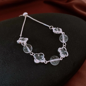 Close-up of zircon clover bracelet with silver finish and adjustable slider clasp