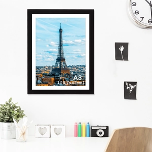 Minimalist black A3 PVC photo frame 29.7x42cm hanging in a modern home office setting