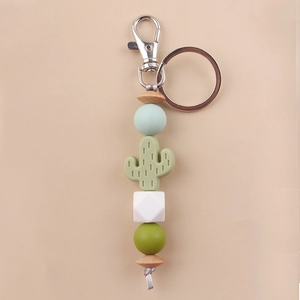 Detailed view of cactus silicone beads keychain with mint green and wooden beads