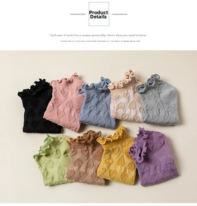 Flat lay of cotton heart pattern socks with ruffle trim in nine pastel colors