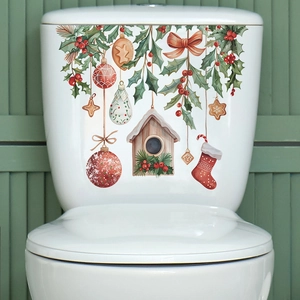 Macro detail of festive Christmas birdhouse and gingerbread stickers on toilet tank