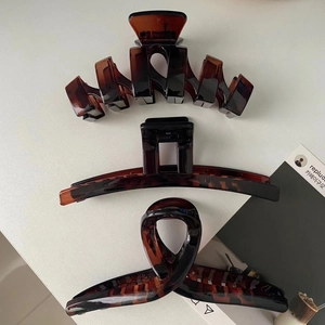 Three amber tortoiseshell hair clips in geometric shapes for a modern Korean style