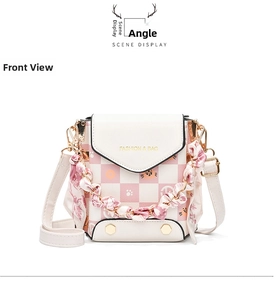 Detailed front view of pink checkered crossbody phone bag with cat pattern and silk scarf