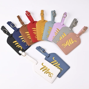 Close-up of colorful PU leather luggage tags with golden Mrs. embroidery and metal buckles
