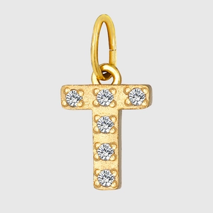 Detailed macro view of a gold T-letter pendant encrusted with sparkling cubic zirconia