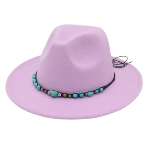 Detailed shot of lavender felt cowboy hat with turquoise bead band and boho style texture