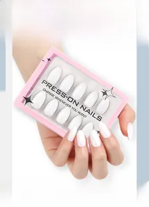 Short almond press-on nails in solid white finish inside a pink window display box