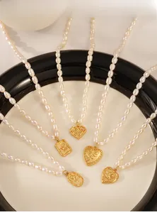 Detailed view of freshwater pearl necklaces with various gold butterfly and rose pendants