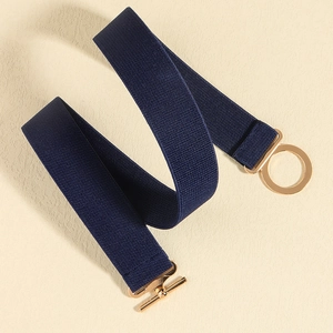Detail of navy blue elastic waist belt with a polished gold round metal buckle and T-bar