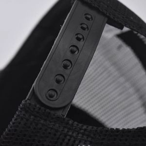 Close-up of adjustable snapback strap and breathable mesh on black trucker hat