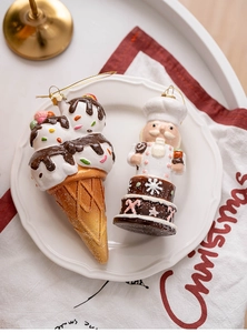 Close-up of gingerbread style ice cream and chef Christmas tree ornaments on a plate
