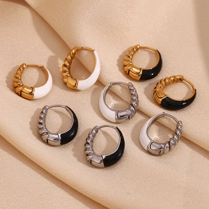Detailed flat lay of twisted 18K gold plated pear drop earrings on silk background