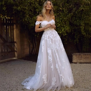 Lace applique wedding dress with off-the-shoulder design and full tulle skirt