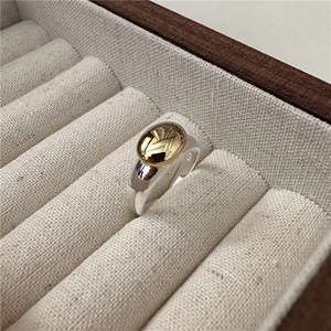 Minimalist S925 sterling silver ring with gold oval top on fabric jewelry box