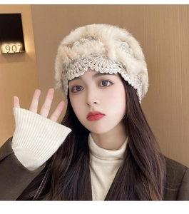 Detailed knit texture of beige rabbit fur crochet beanie with hollow floral patterns