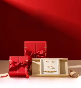Detail of red embossed jewelry box with ribbon bow and soft beige velvet interior